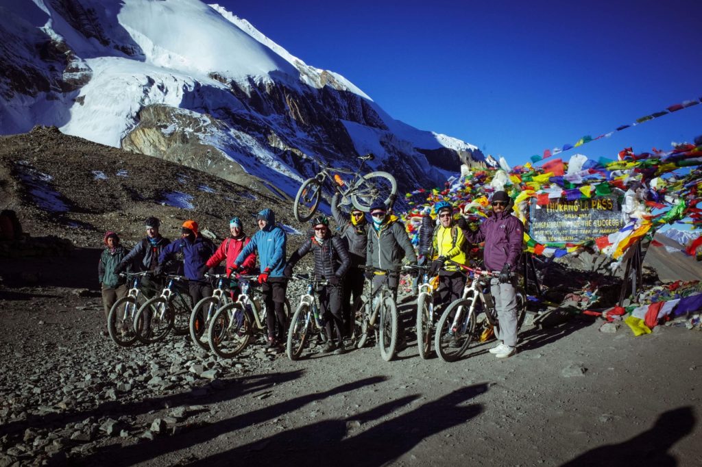 Cyclists at Thorong La Pass - Annapurna Circuit MTB Tour
