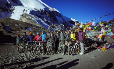 Cyclists at Thorong La Pass - Annapurna Circuit MTB Tour